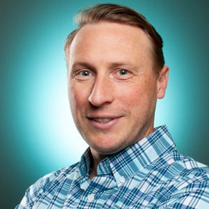 elliott-rebuck-portrait-blue-shirt-and-background-square